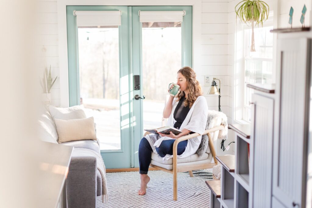 day in the life holistic lifestyle branding session photos, morning routine in her tiny house, sipping tea